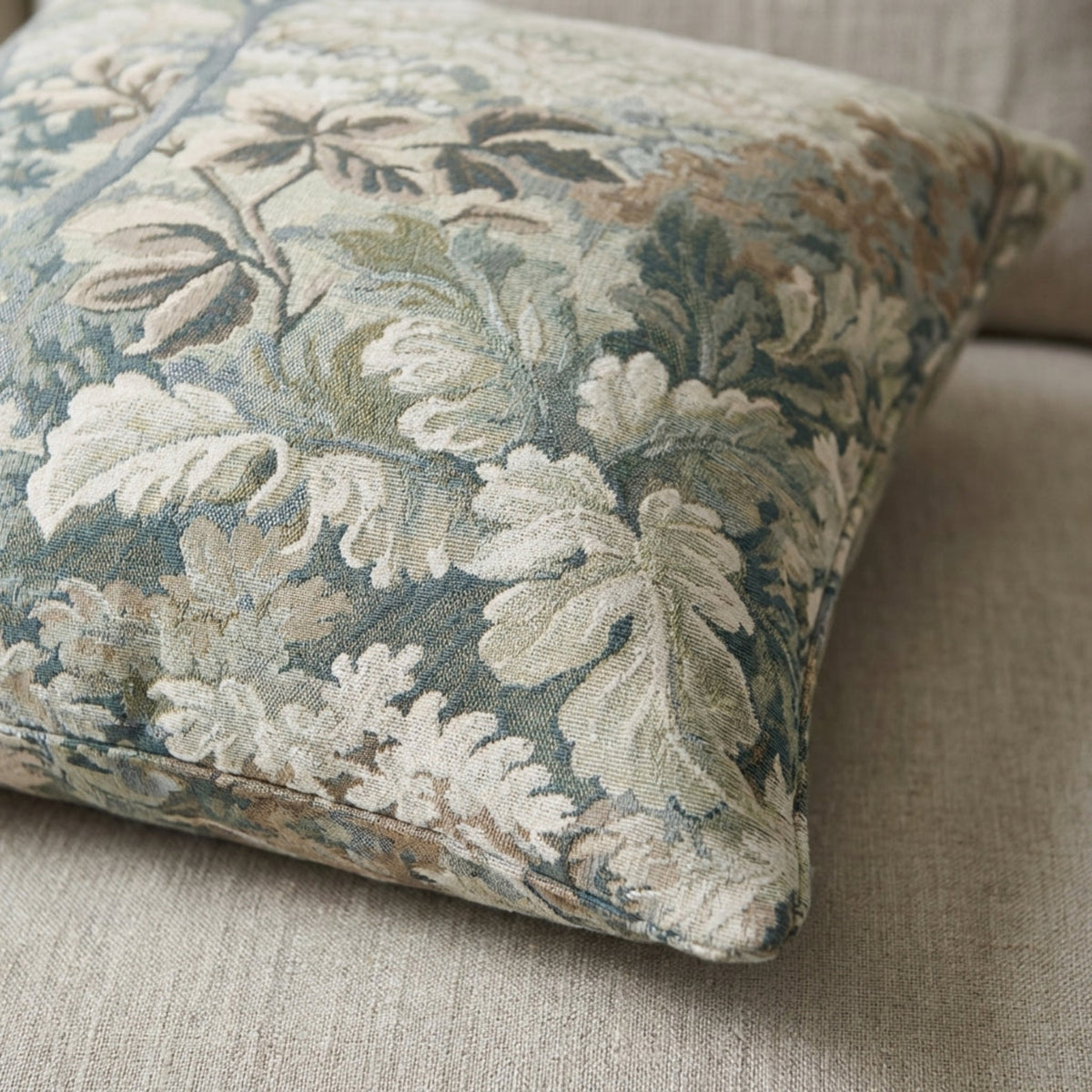 Close-up of the Callahan Pillow Cover showcasing intricate botanical tapestry pattern, detailed fabric texture, and muted color palette in natural light.