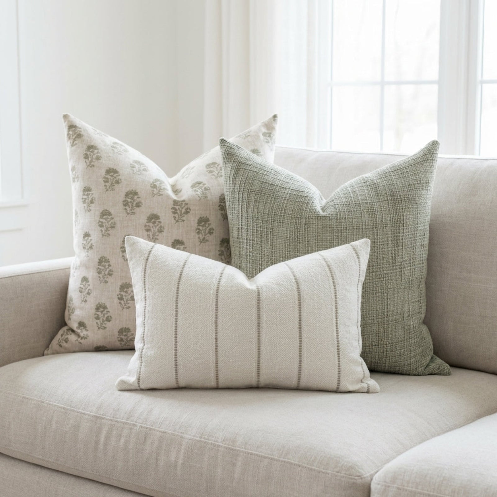 Close-up of the Cecily Pillow Cover highlighting fabric's micro-texture and delicate block print, set against a soft, airy background.