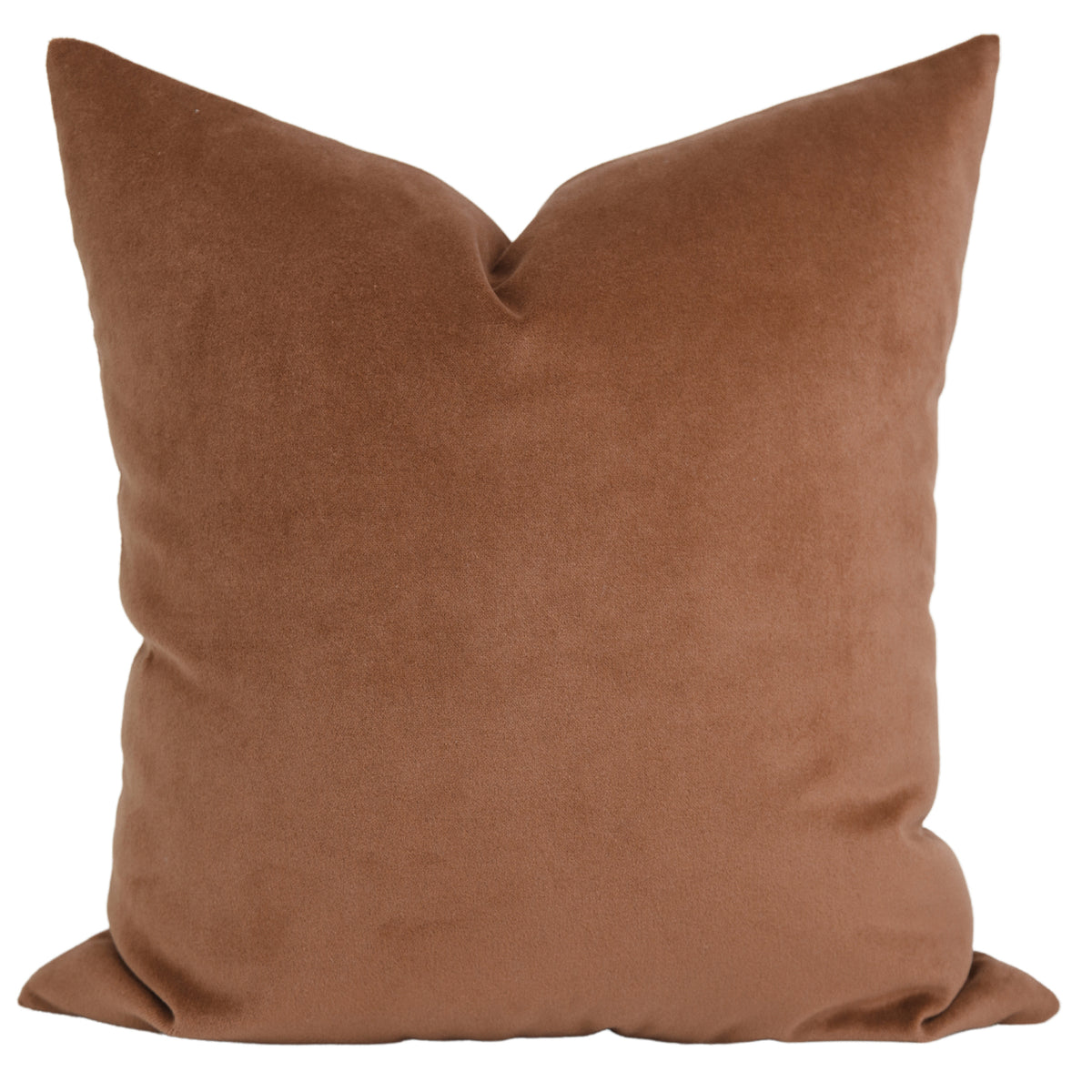 A solid, rust-colored pillow made from smooth and velvety fabric.
