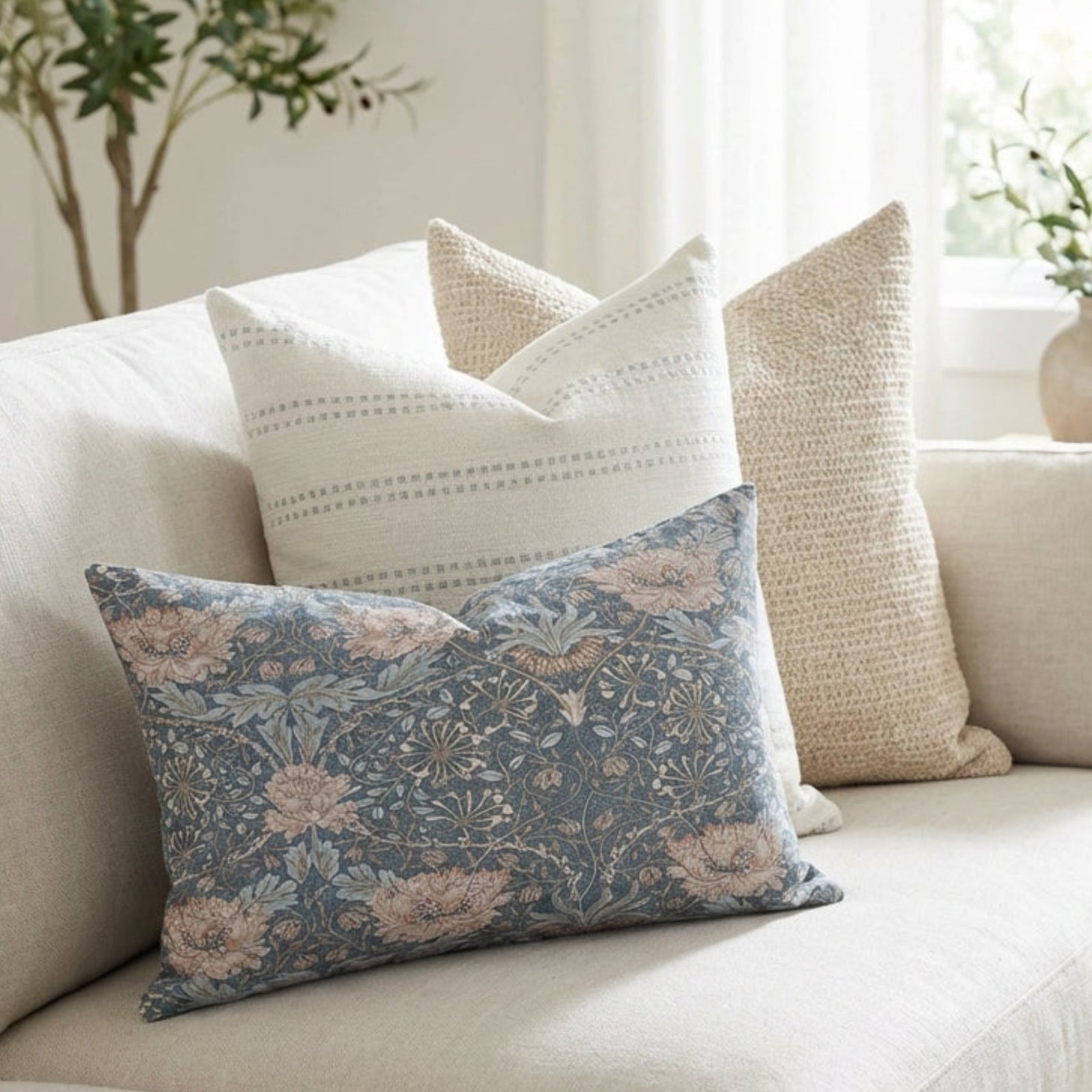 Sofa decorated with the Single-Sided Combo 6 pillow covers in blue, neutral tones, and textured fabrics, creating a relaxed, airy living space.