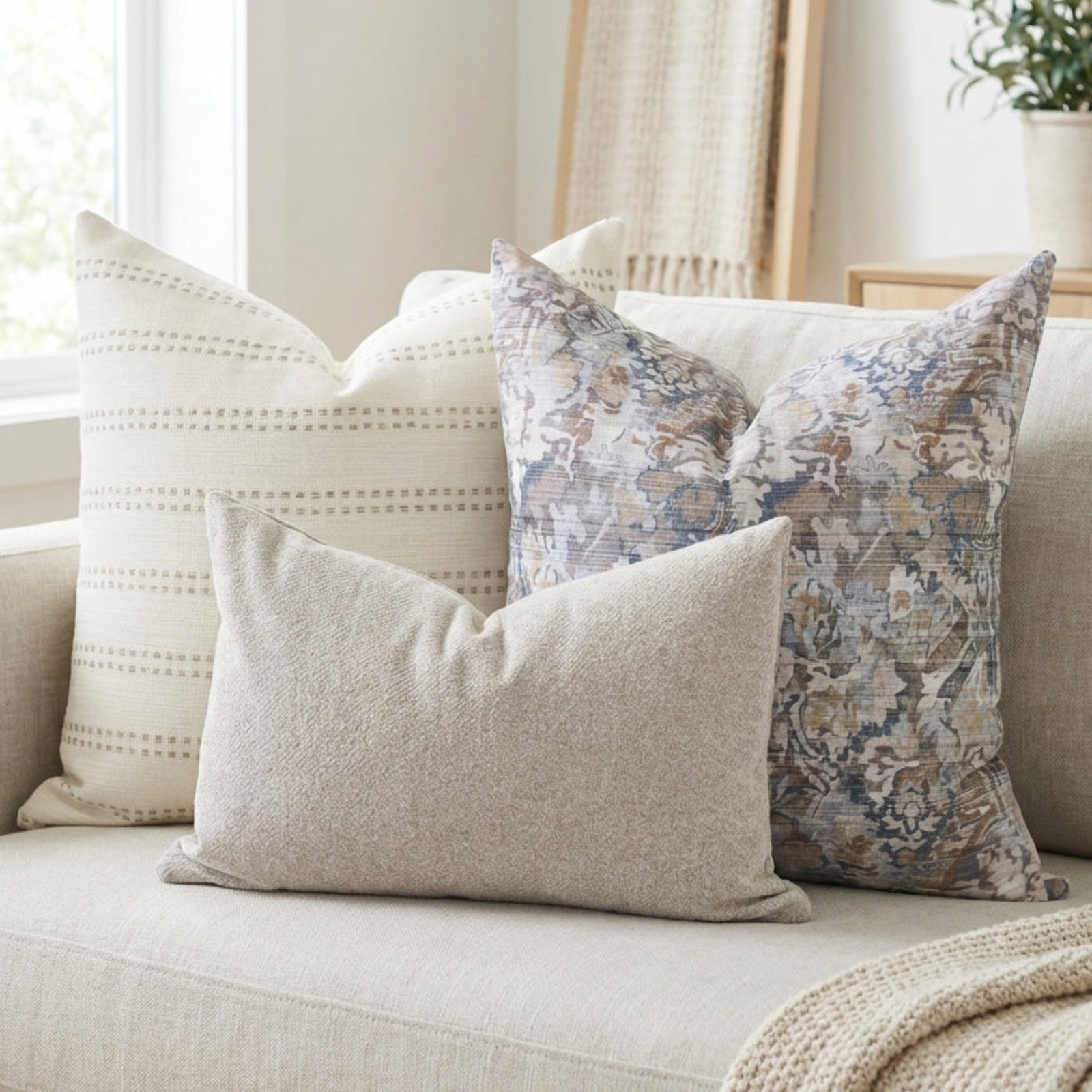 Three pillow covers from the Combo 20 set arranged on a neutral-toned airy sofa, highlighting their textures and natural, minimalist aesthetic.