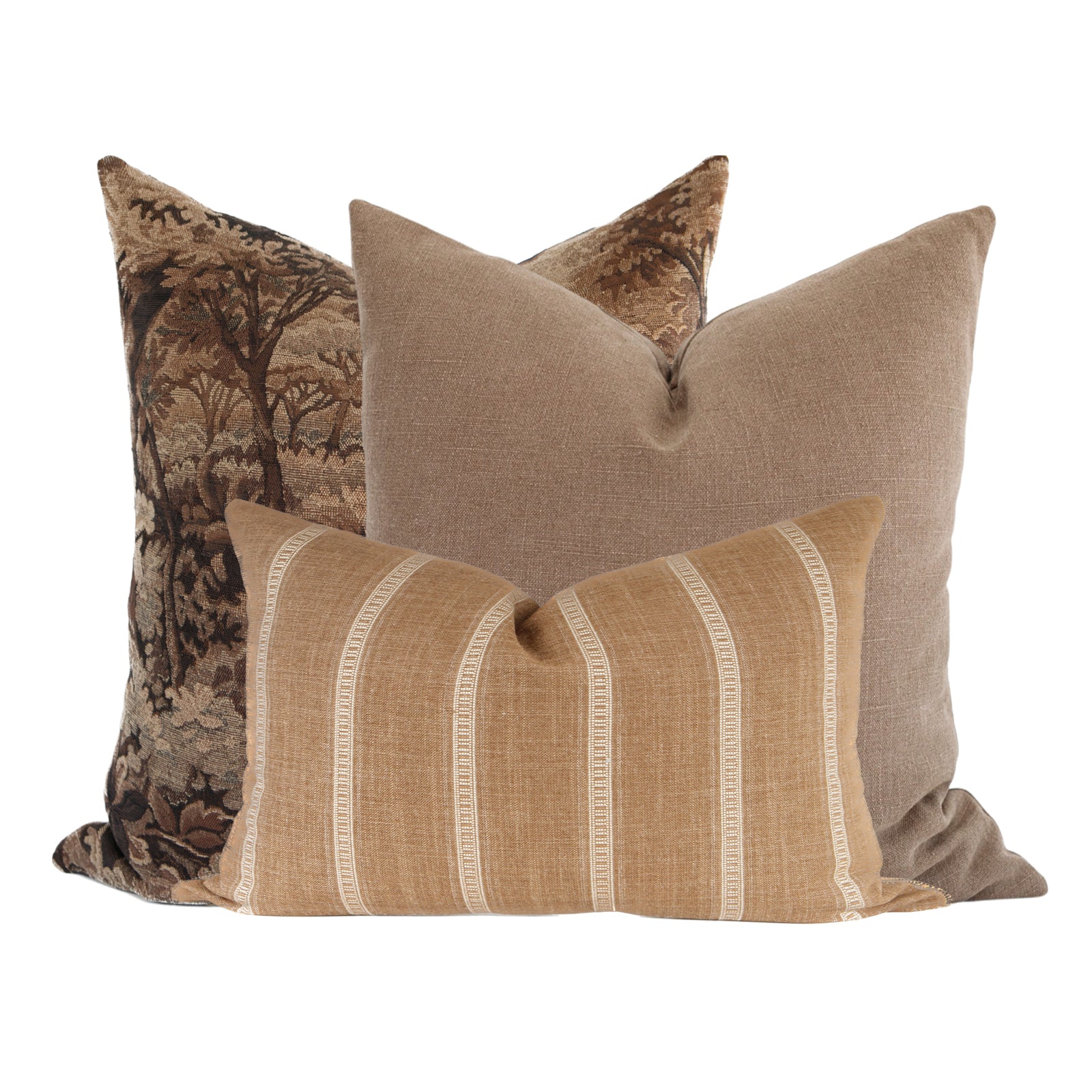 Close-up of three Finnegan pillow covers on a plush sofa, highlighting textures and intricate tapestry in an airy living room.