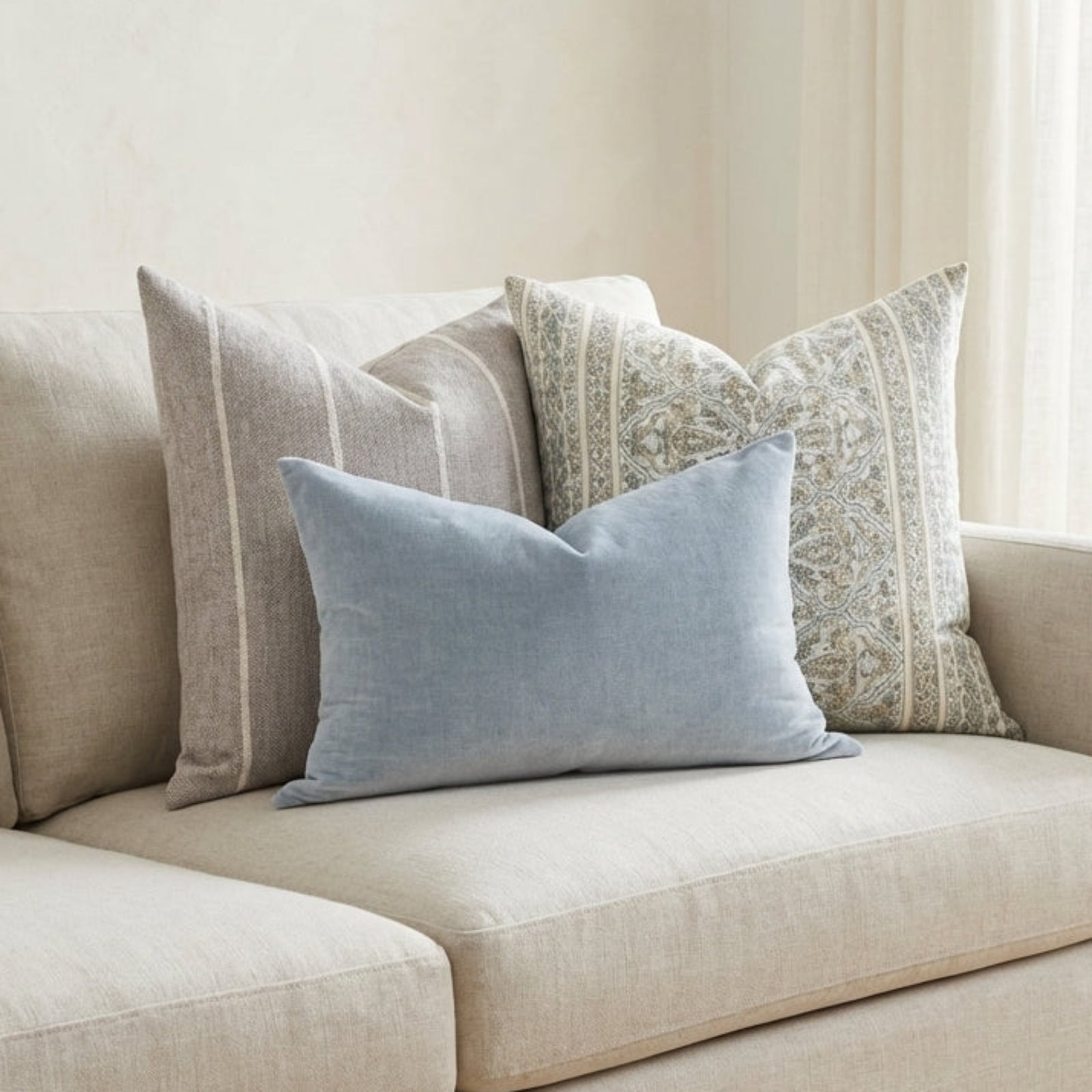 Neutral-toned sofa styled with Gage Pillow Combo 1 in a minimalist, airy room with soft natural textures.