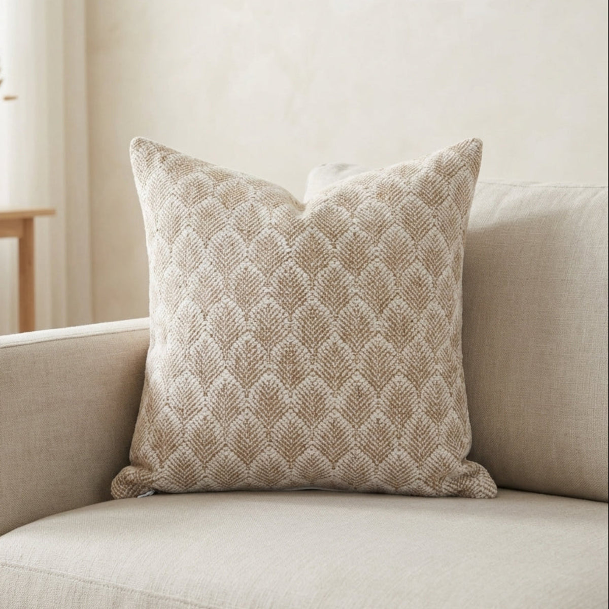 Full view of the Whitaker Pillow Cover on a modern sofa in a minimalistic living room, showcasing its design, crisp edges, and invisible zipper.