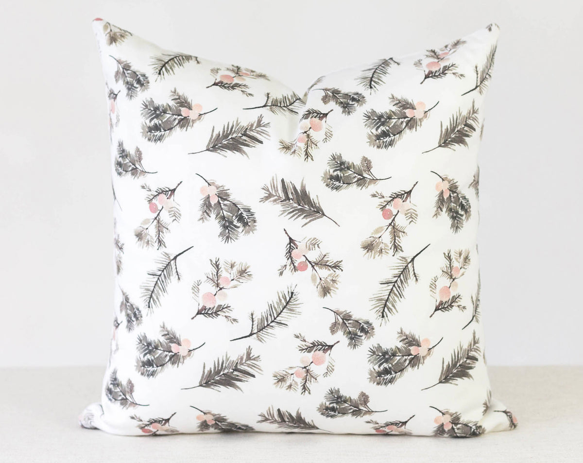 Features a soft white background adorned with delicate brown pine sprigs and subtle blush pink berries.
