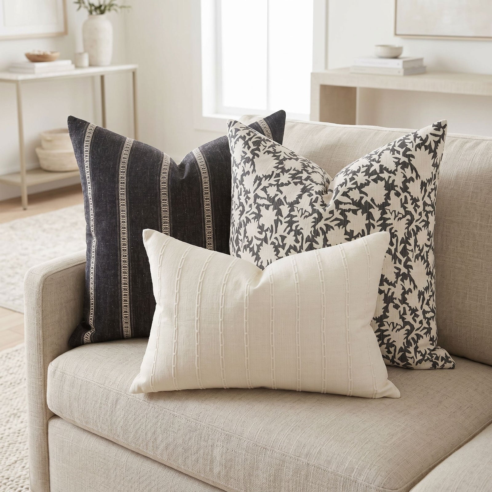 Realistic interior showing Xavier Sofa Combo 3 pillows arranged on a sofa in a neutral, spacious room with soft lighting.