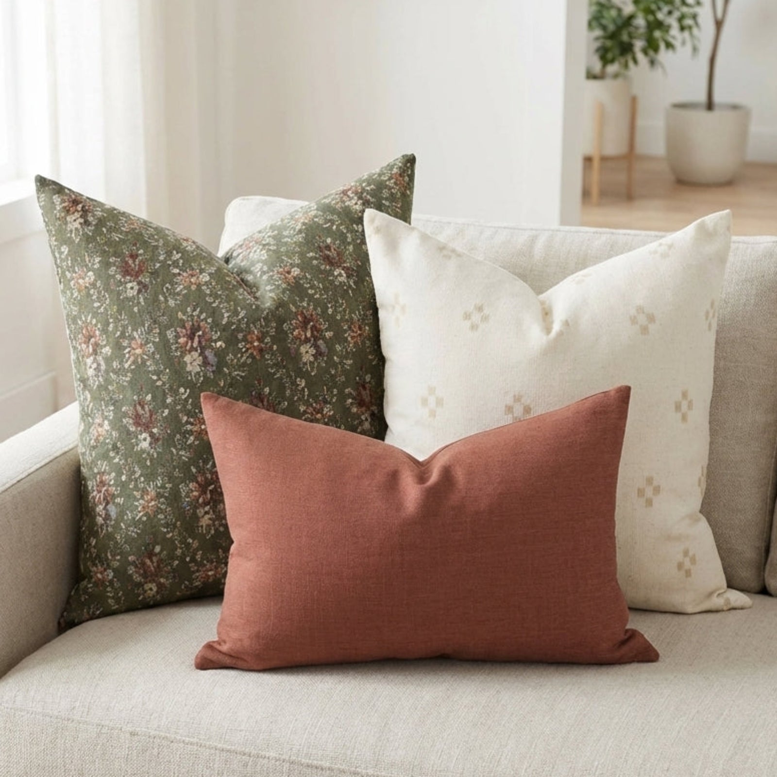 Casual arrangement of the Hailee Sofa Combo 2 pillows on a neutral airy sofa in a minimalist living room emphasizing textures and patterns.