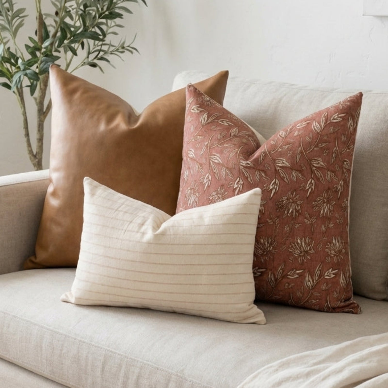 Casual arrangement of Terracotta Sofa Combo 1 pillows on a neutral, airy sofa, emphasizing natural textures, soft lighting, and relaxed, cozy ambiance.