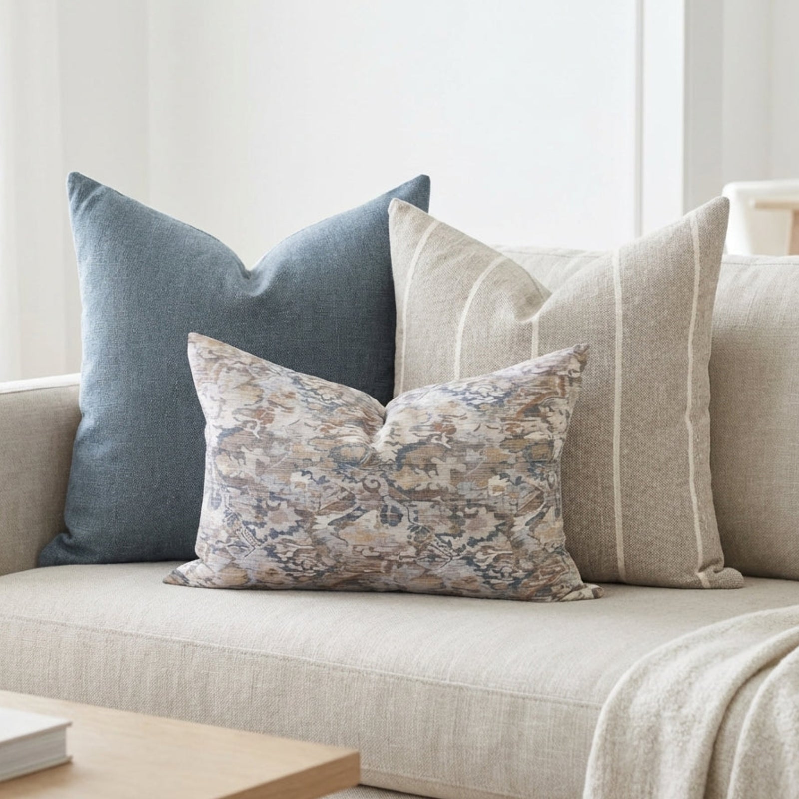 Gage Sofa Combo 3 pillows arranged on a neutral, airy sofa in a cozy living space, highlighting textures, fabric details, and zipper features.
