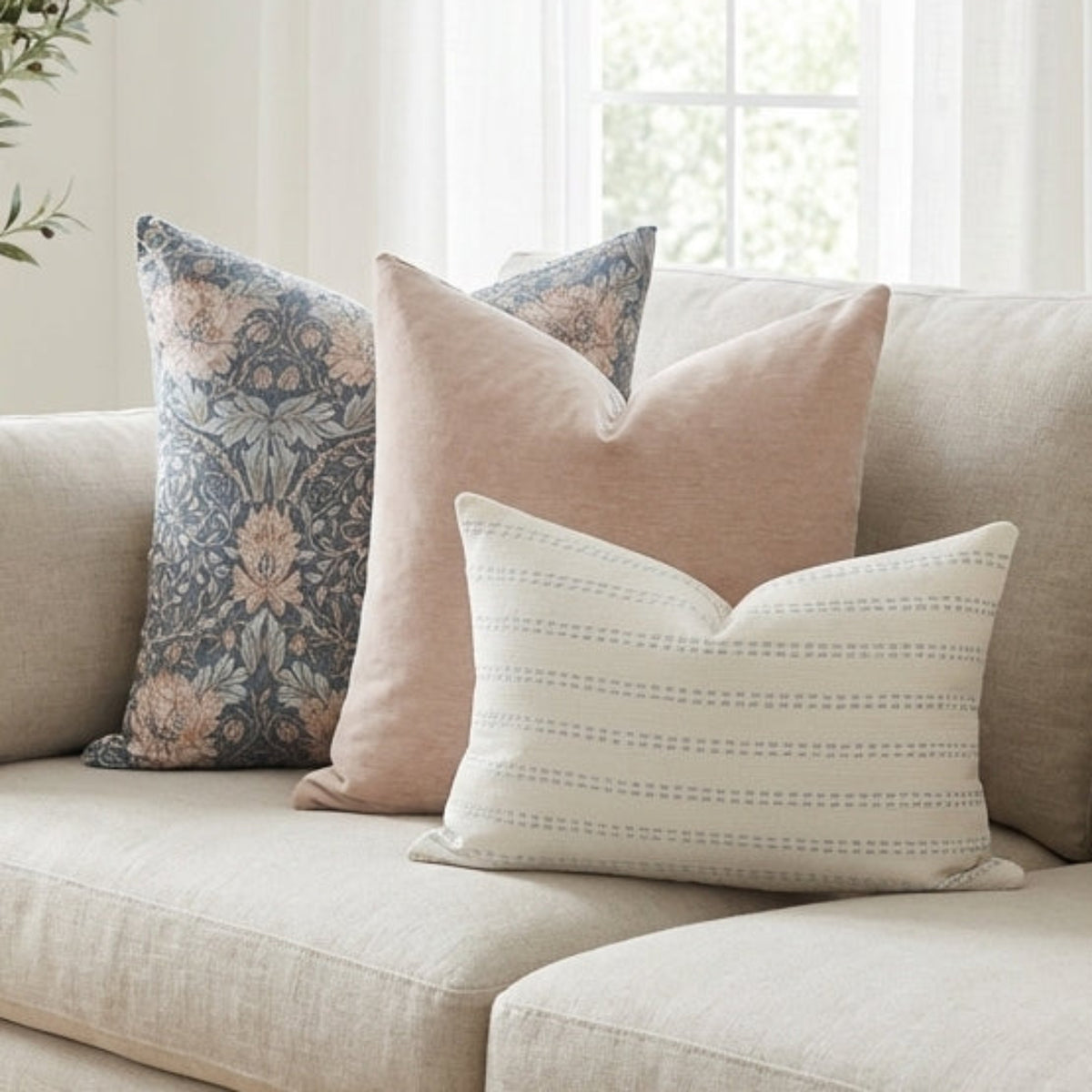 Full view of Oversized Combo 7 pillows arranged on a light sofa demonstrating relaxed, modern style and neutral color palette.