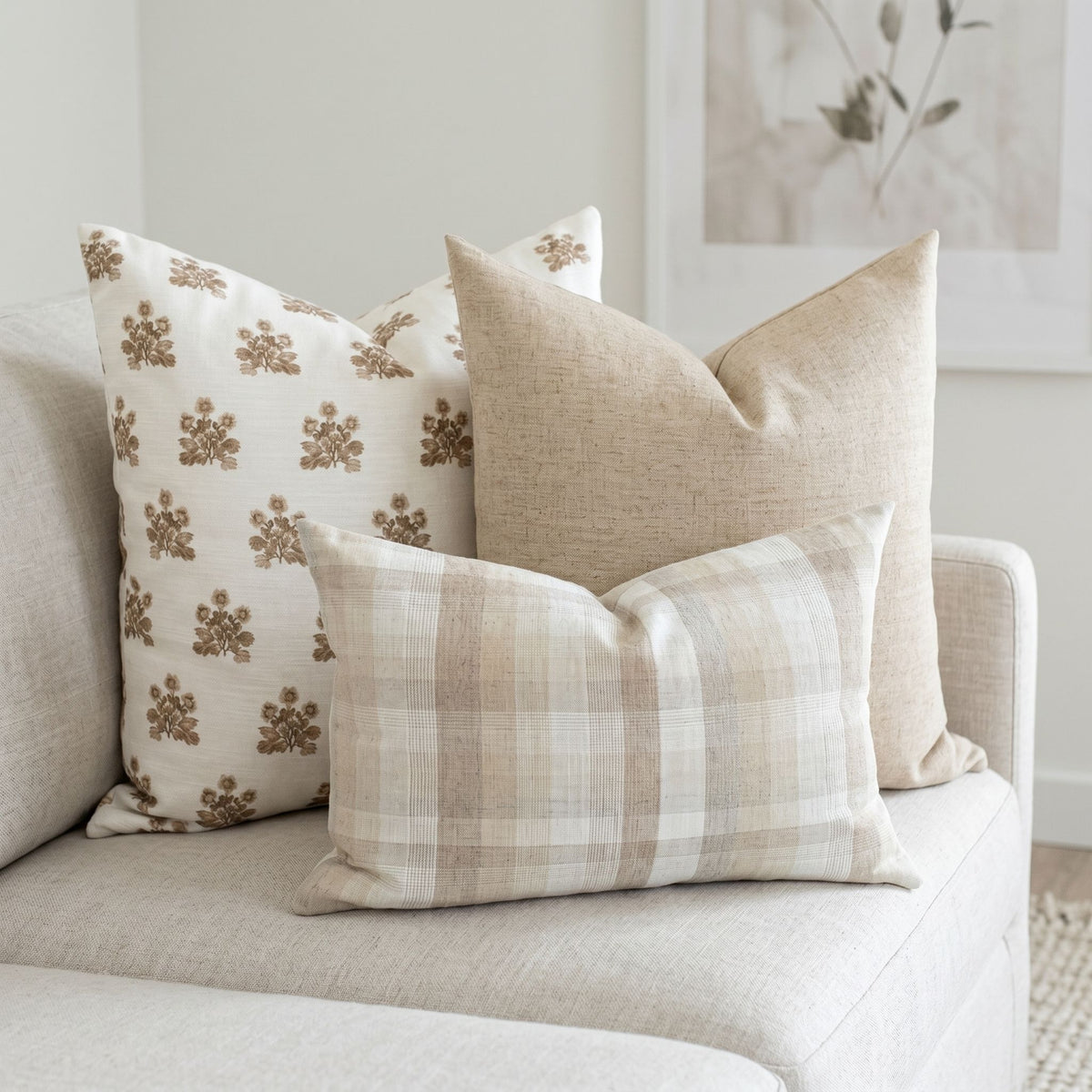 Scarlett Sofa Combo 2 pillows arranged on a neutral-toned airy sofa in a modern light-filled living room, showcasing vintage-inspired patterns and organic fabrics.
