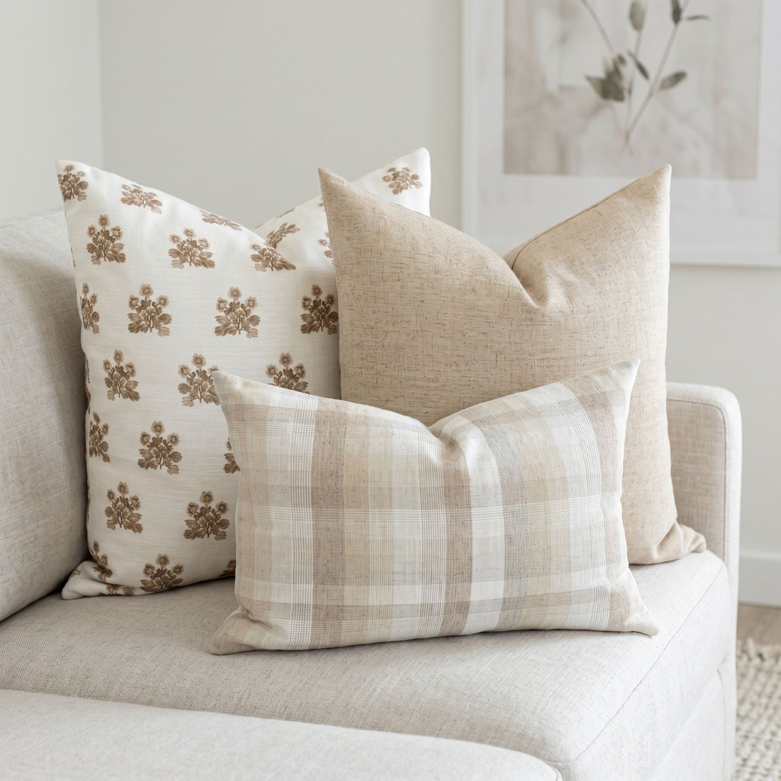 Scarlett Sofa Combo 2 pillows arranged on a neutral-toned airy sofa in a modern light-filled living room, showcasing vintage-inspired patterns and organic fabrics.