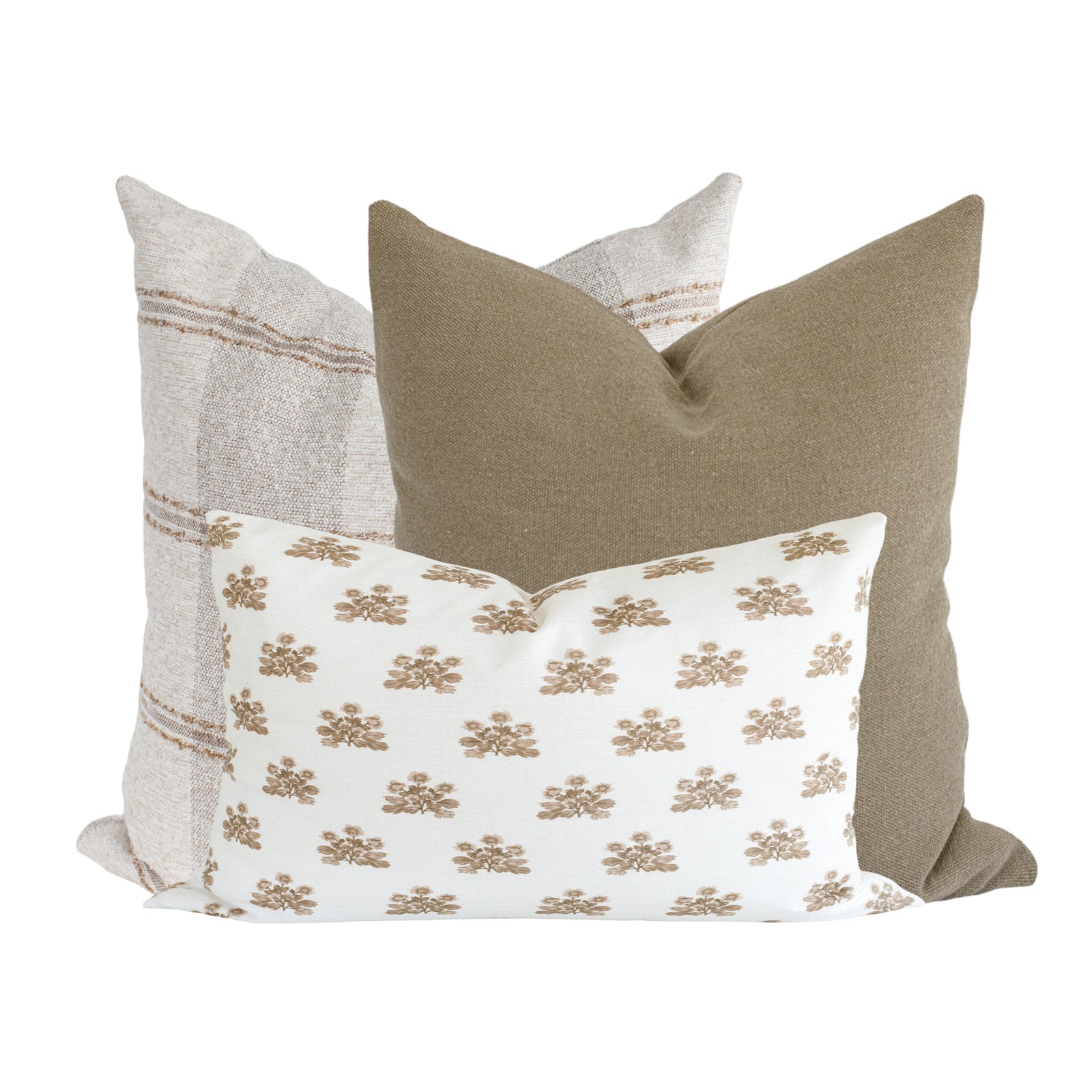 Sofa with Stetson, Brit, and Scarlett pillows arranged on a modern, neutral sofa in a bright, airy living room, showcasing textured fabrics and vintage patterns.