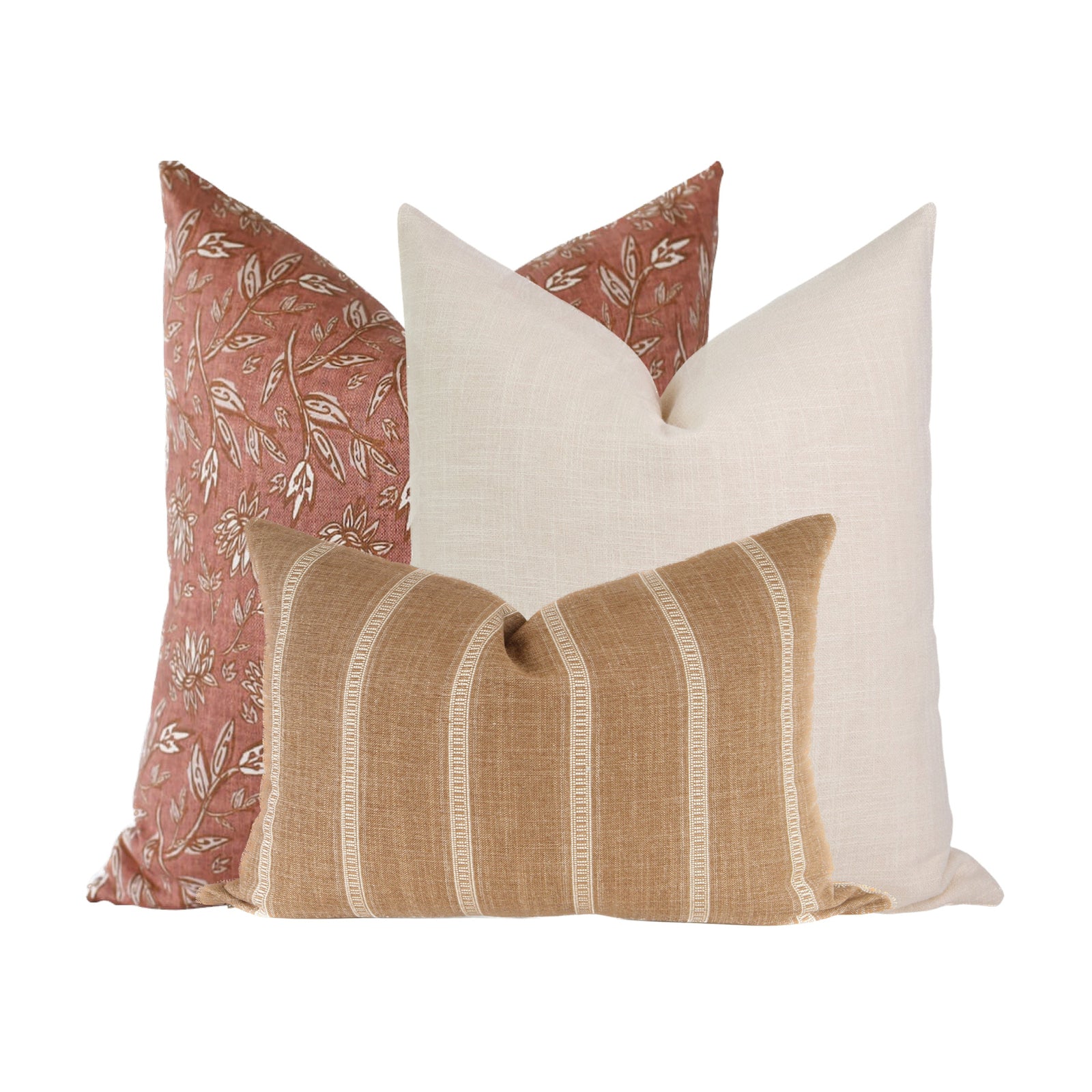 Full view of a sofa with three coordinated pillows on a neutral, airy living space emphasizing texture and layered styling.