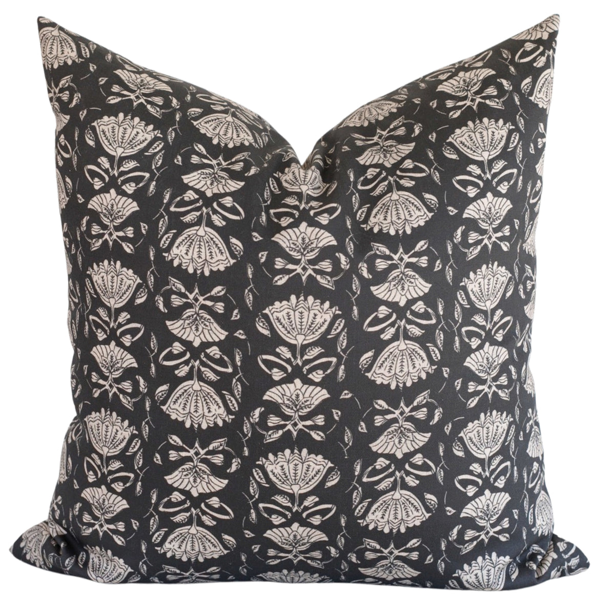 A soft beige floral block print on a deep, muted black background.